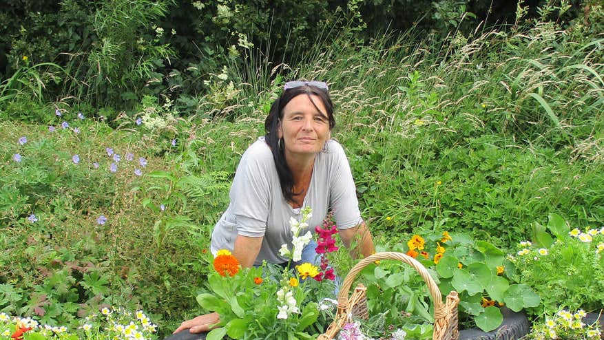 Lisa Guinan with flowers in garden