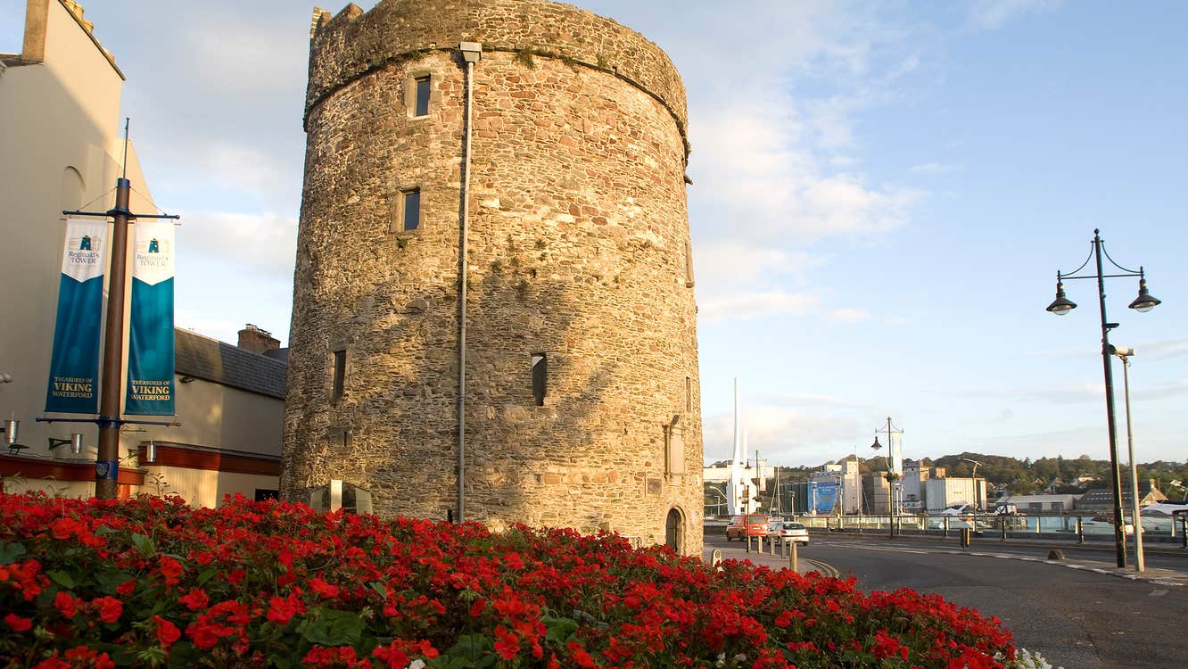 Flowers in a bed outside the exterior of Reginald's Tower in Waterford