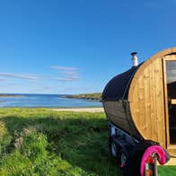 A wooden sauna overlooking a beach