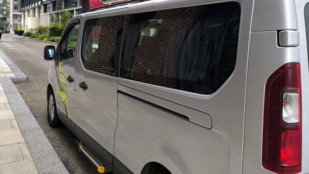 A silver van parked along a street kerb