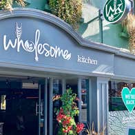 A view of the front door and entrance to the Wholesome Kitchen
