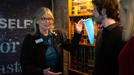 A guide speaking to two visitors