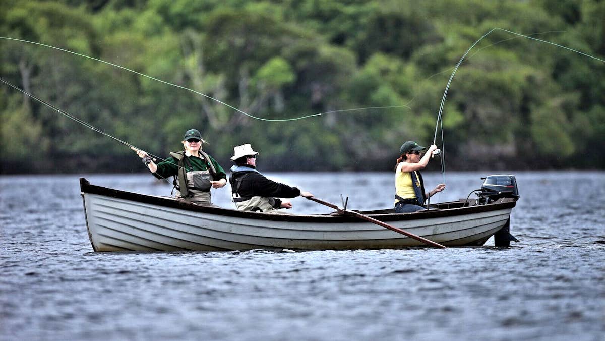 People fishing off a small boat in the Lakes of Killarney with Anglers Paradise Fishing Guides Killarney