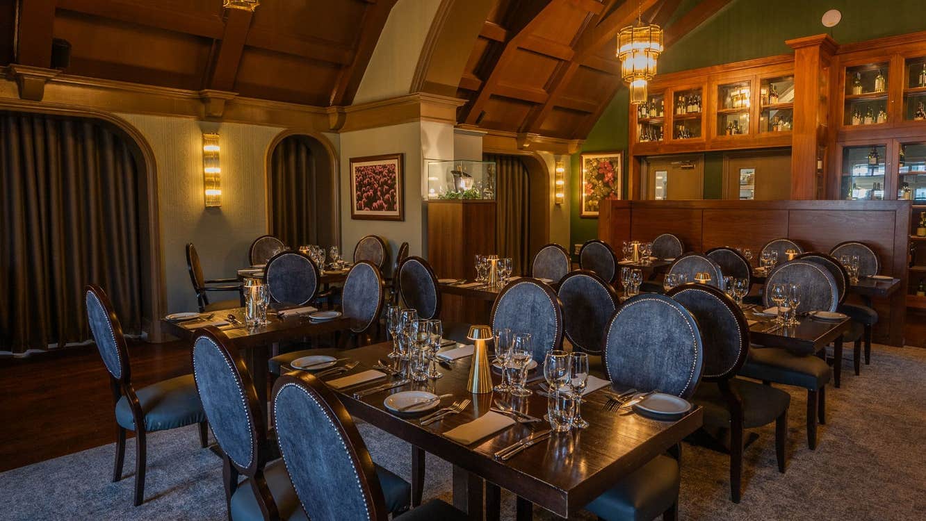 Restaurant with a domed shaped ceiling and chairs by tables set for service