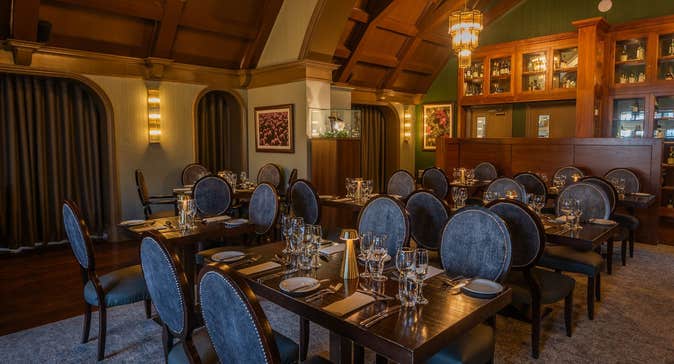 Restaurant with a domed shaped ceiling and chairs by tables set for service
