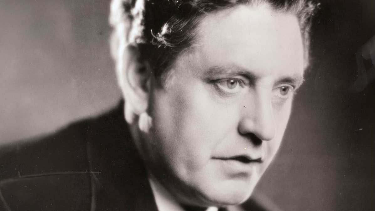 An old photo of head shot of a serious looking man