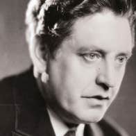 An old photo of head shot of a serious looking man