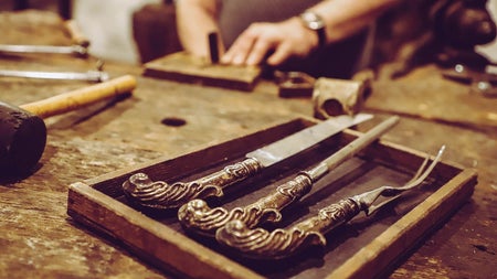 A person working with tools at a work bench