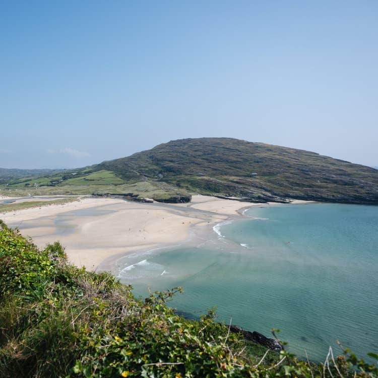 A view of Barley Cove sandy beach sea and surrounding hills