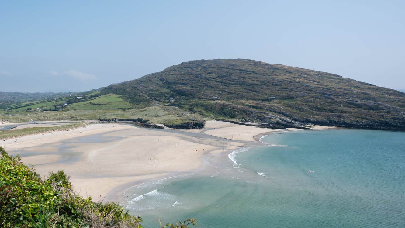 A view of Barley Cove sandy beach sea and surrounding hills