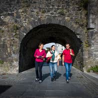 Friends walking through the Spanish Arch, Galway City