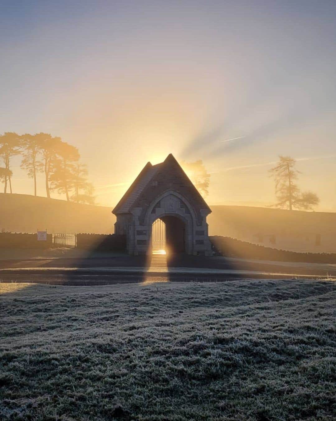 The sun setting behind the gates of The Curragh in Kildare at winter time.