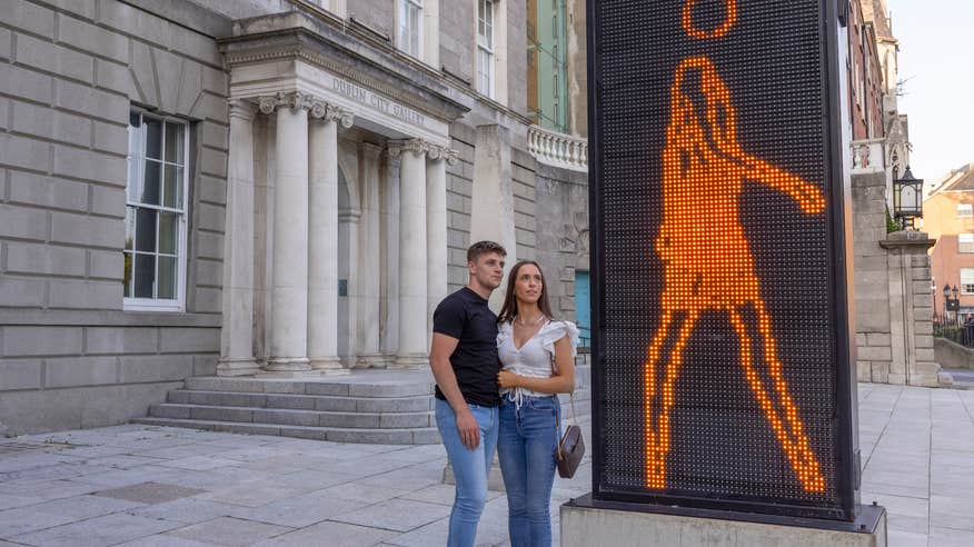 A couple admiring the modern art installation outside of the Hugh Lane Gallery in Dublin city.