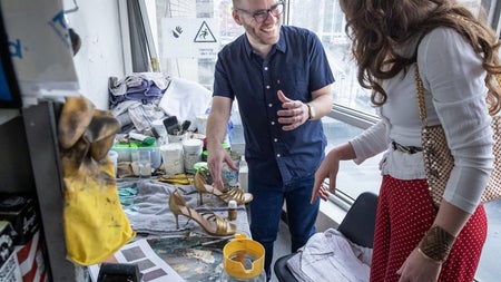 Theatre tour guide showing someone props and costumes