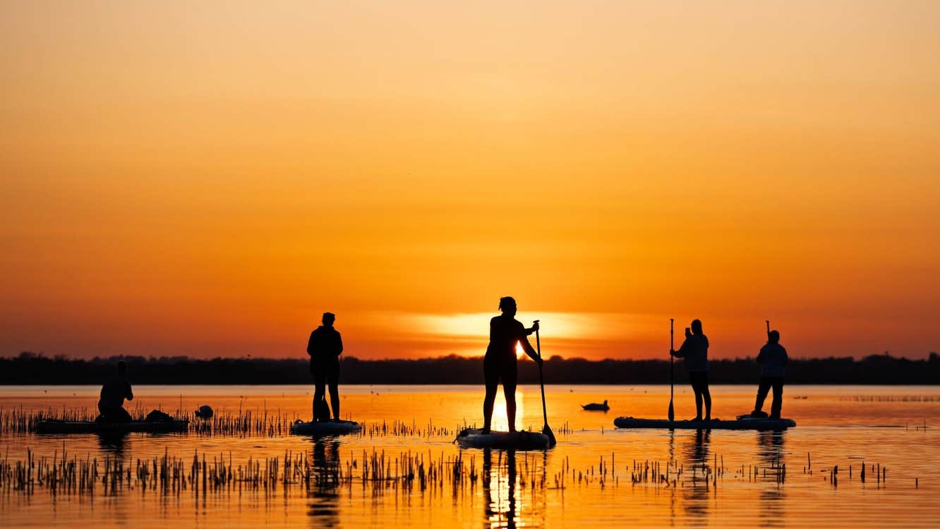 Stand up paddle boarding at sunset with SUPwell Ireland