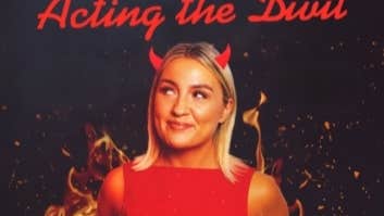 Enya Martin with new show, Acting the Divil, a smiling woman in red dress with little red horns coming out of her head