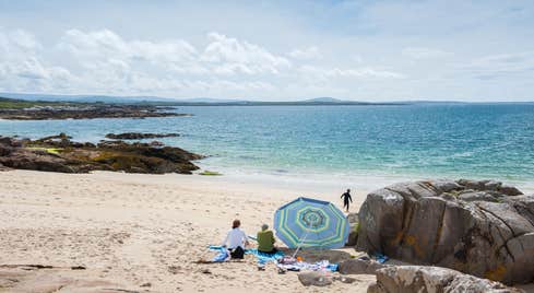 A group of people on Gurteen Beach, Galway on a sunny day