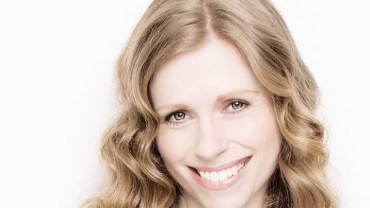 Fionnuala Moynihan is smiling in front of a white background.