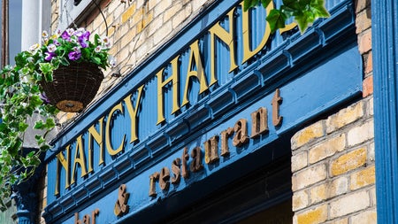 The blue and gold exterior of Nancy Hands Bar & Restaurant