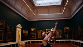 Dancer in the Shaw room, National Gallery of Ireland. Arms raised through a circular horn instrument.