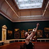 Dancer in the Shaw room, National Gallery of Ireland. Arms raised through a circular horn instrument.