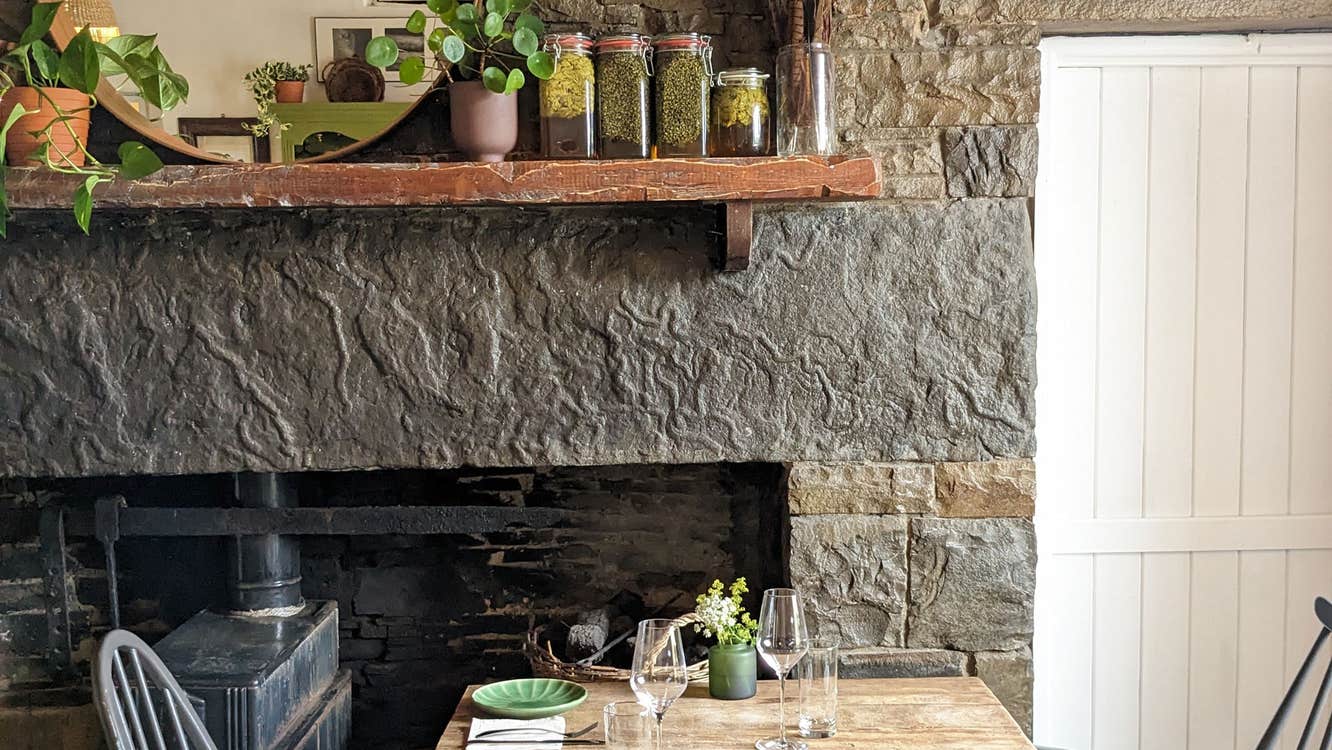 Homestead Cottage Doolin interior table by a fireplace