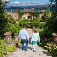 Couple walking down steps towards Bantry House and Gardens, Cork