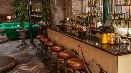 Copilot said:
Bar area of Idlewild exposed brick walls and mirrored shelving