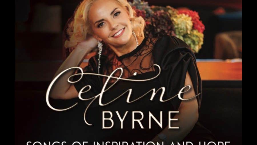 Celine Byrne - Songs of Inspiration & Hope - a smiling woman in black dress, leaning on her right raised hand.