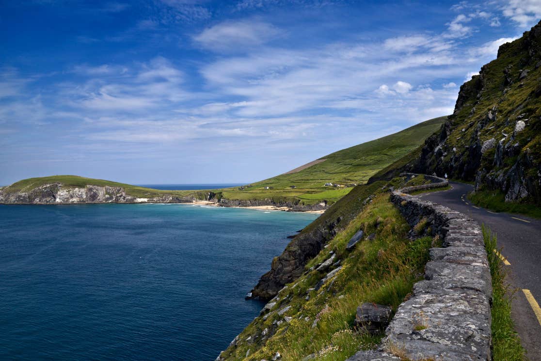 A road and stone wall leading to a beach on Slea Head, Dingle, Kerry