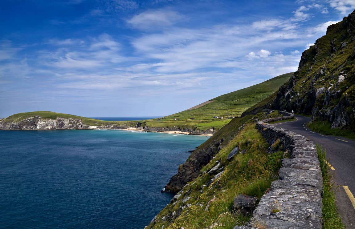 A road and stone wall leading to a beach on Slea Head, Dingle, Kerry