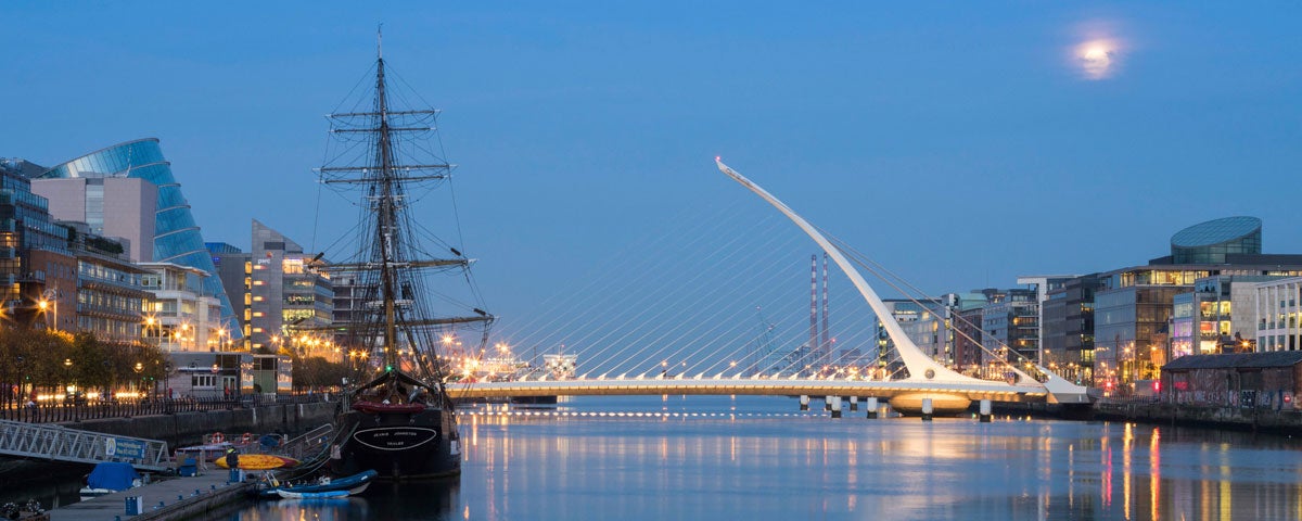 The Samuel Beckett Bridge at night with the Jeanie Johnston tall ship in the foreground