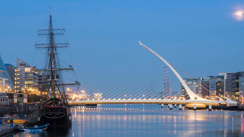 The Samuel Beckett Bridge at night with the Jeanie Johnston tall ship in the foreground