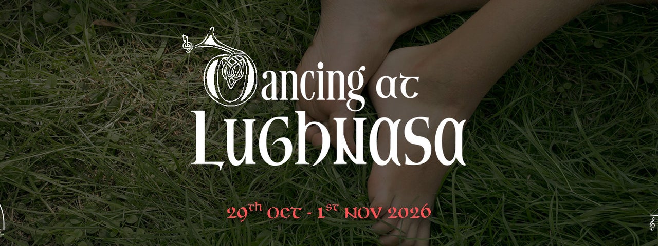 Feet in the grass with the title of the play in white writing