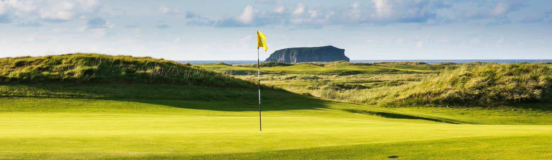 The hole and flag of a Ballyliffin Golf Course in Donegal.