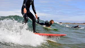 Image of surfers on boards
