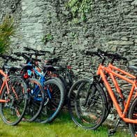 Bikes left up against a stone wall