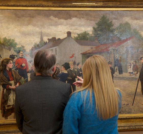 People looking at a painting in the National Gallery of Ireland in Dublin city