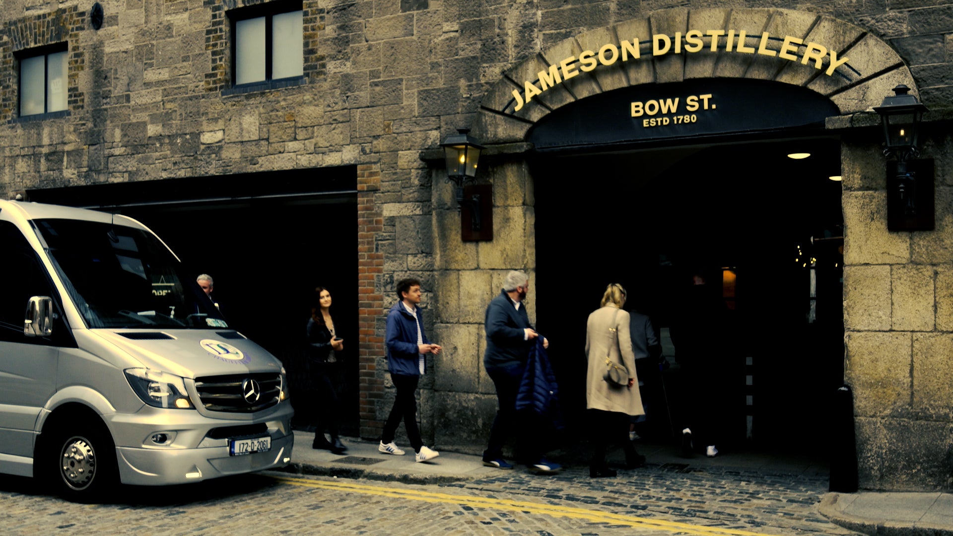A group of people enter the Jameson Distillery in Bow Street