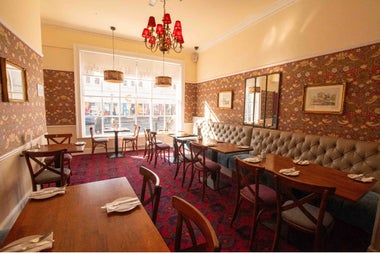An empty tea room with prepared tables