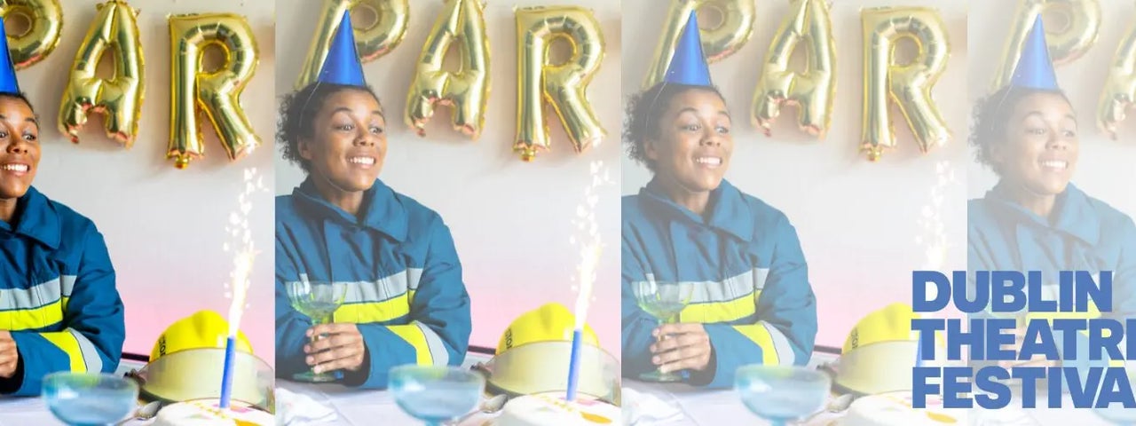 Lola, a firefighter, sits surrounded by birthday decorations