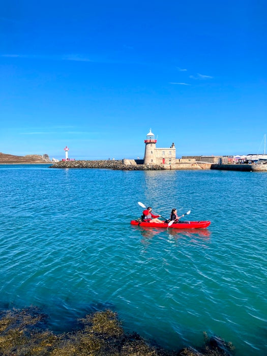 People kayaking past Howth Harbour Lighthouse in Co Dublin