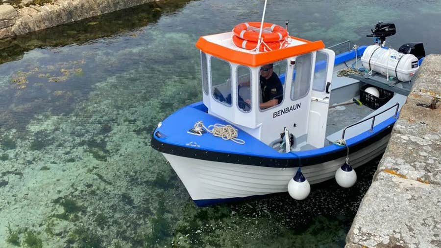A small boat moored at a quay