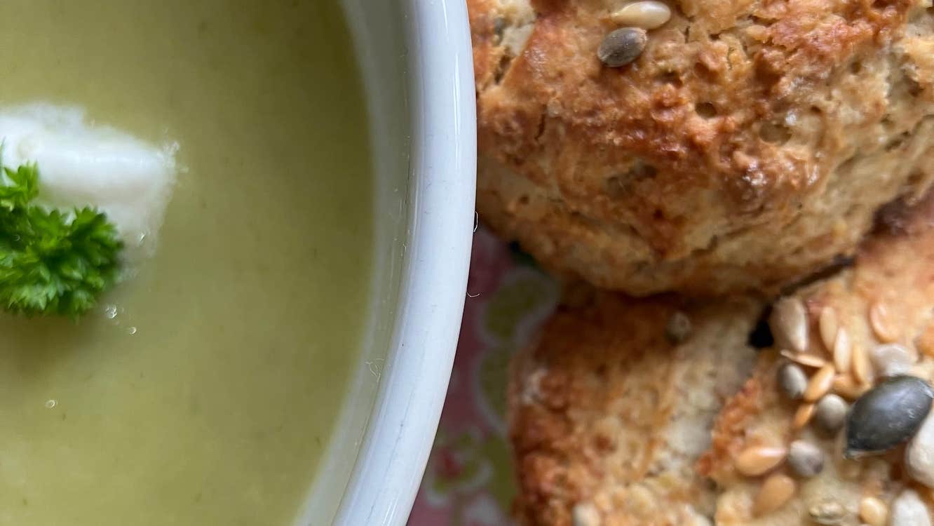 Close up view of a bowl of soup and scones