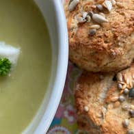 Close up view of a bowl of soup and scones