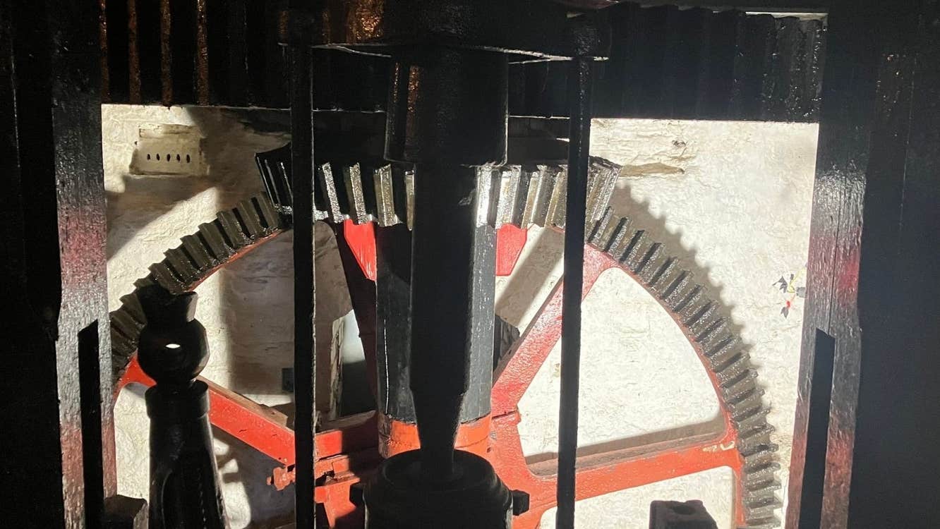 A close up of a metal wheel in a mill
