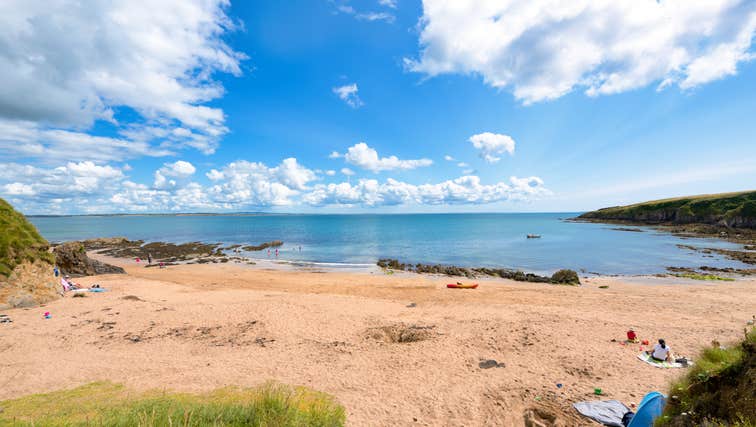 People sitting on the beach at Baginbun Bay in Co Wexford