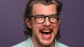 A man laughing with his mouth wide open.