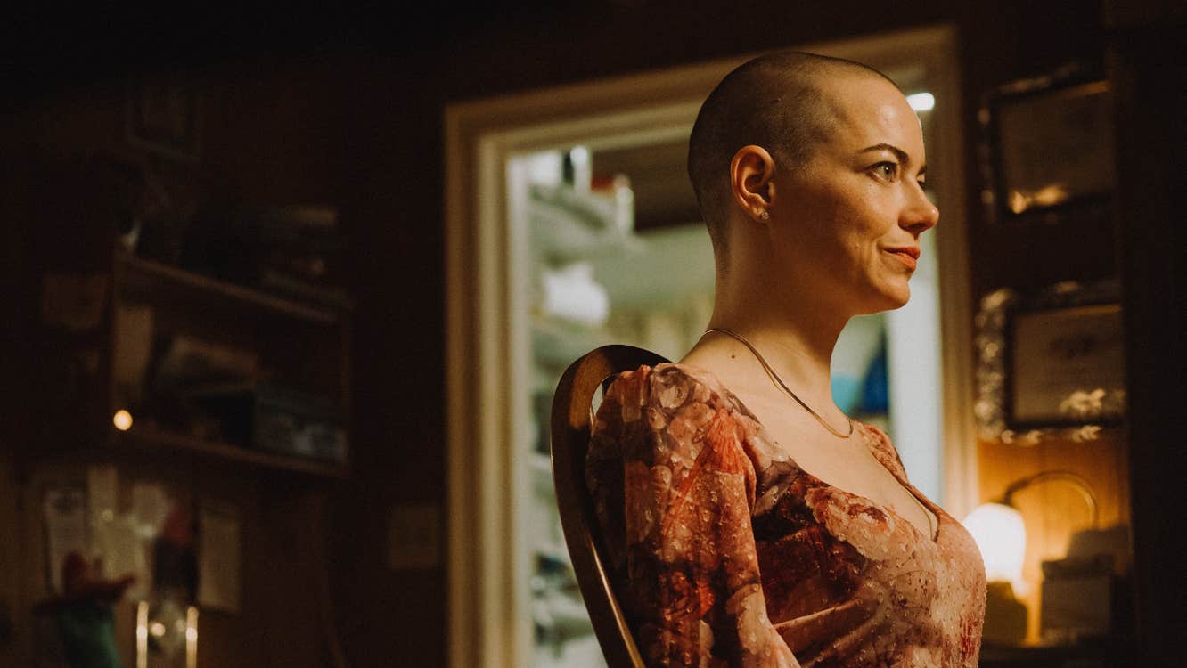 A woman with a shaved head.