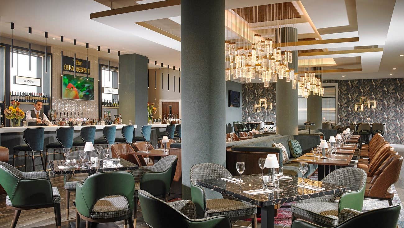 An empty restaurant and bar with dining tables prepared for diners